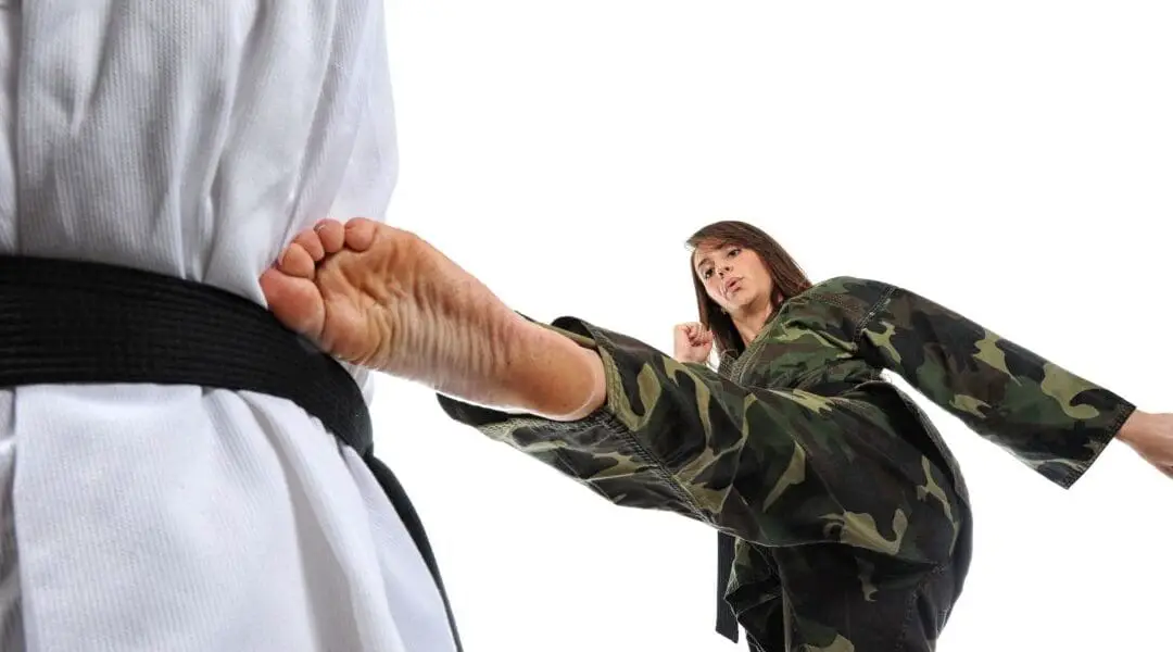 Army female officer kicking in hand to hand combat