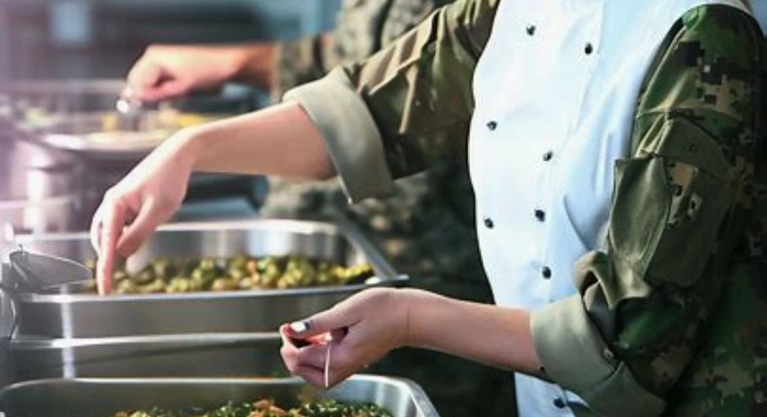 Army person getting food from mess